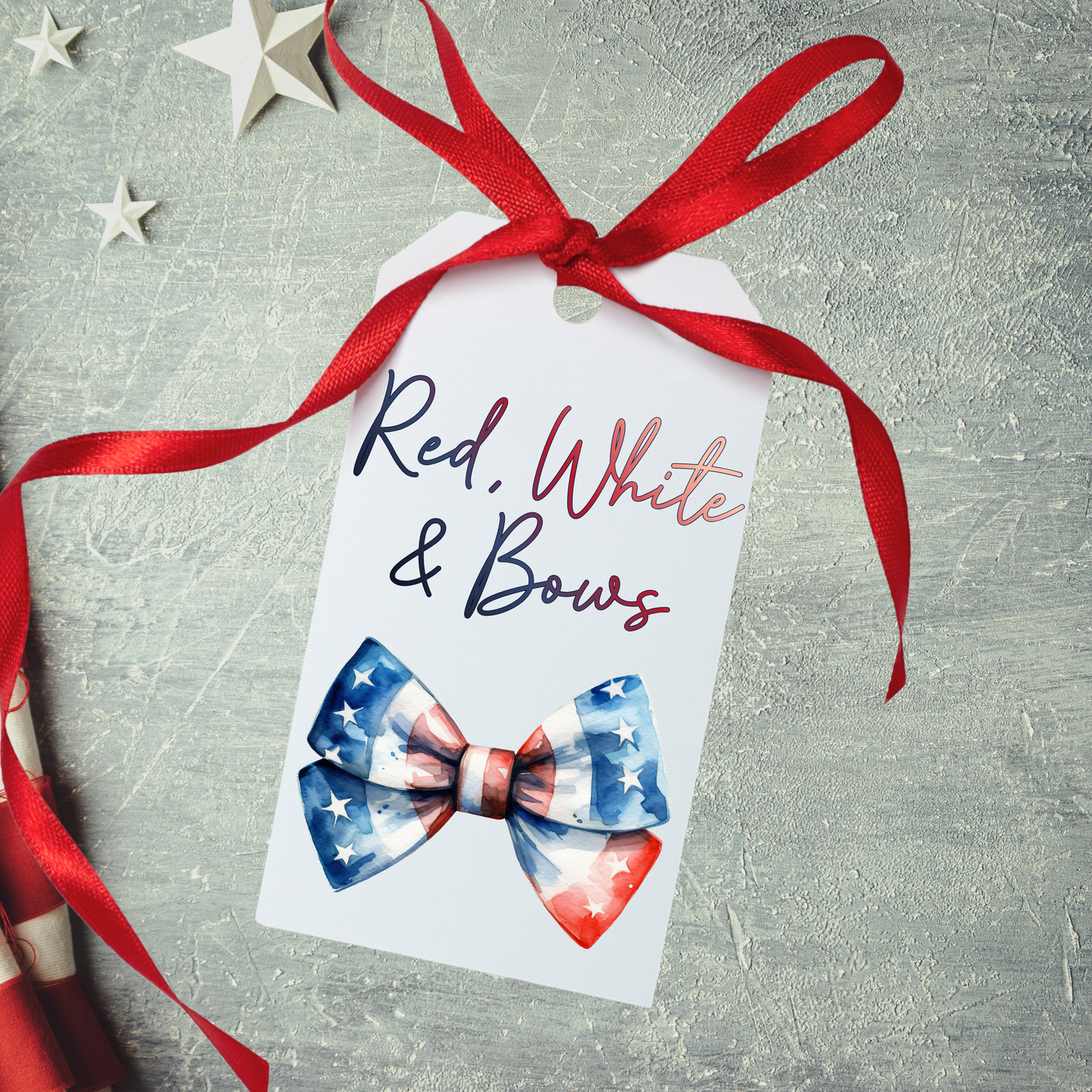 Gift tag with American flag bow design and 'Red, White & Bows' text on a textured surface.