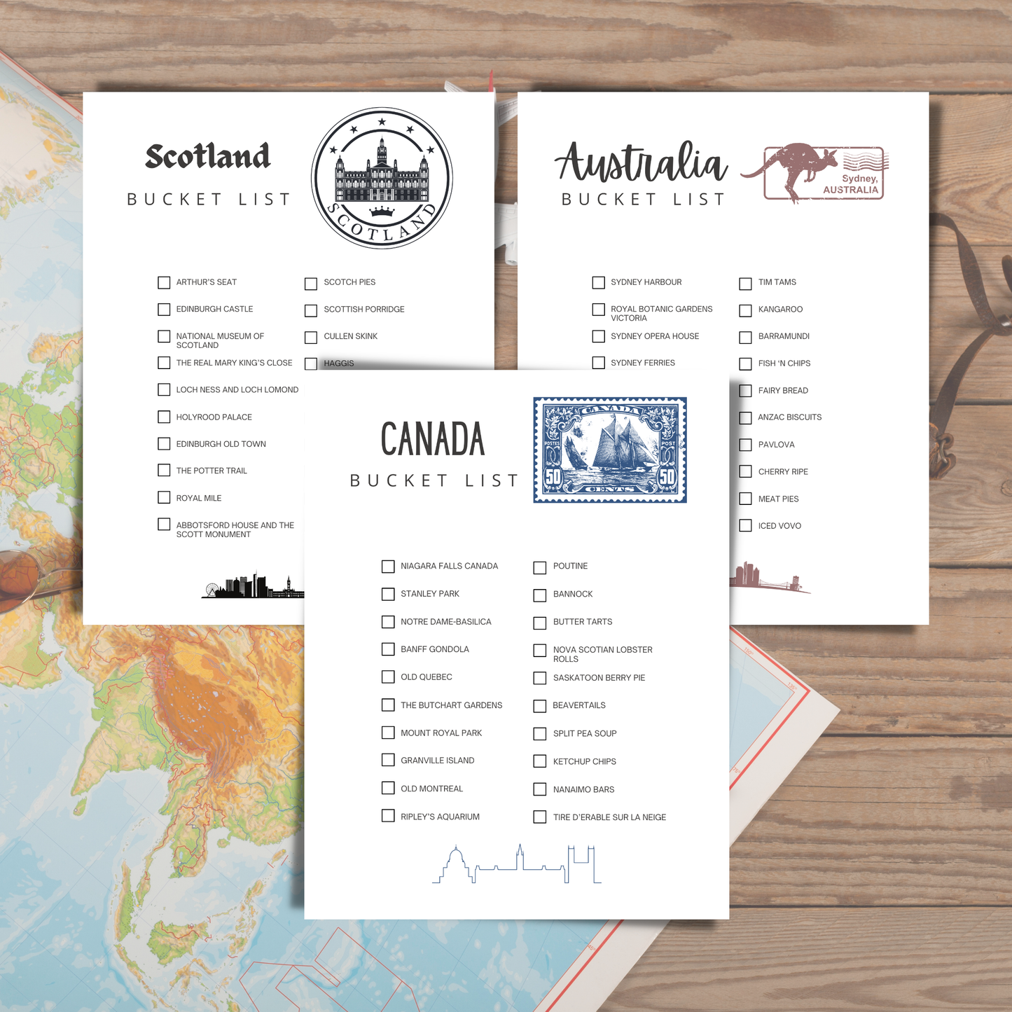 Three bucket list sheets for Scotland, Australia, and Canada on a wooden surface with a map in the background.